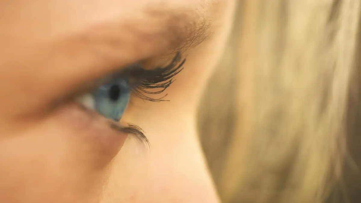 Detailed macro shot showcasing a blue eye and eyelashes, perfect for beauty and medical topics.